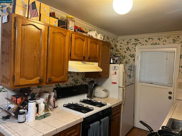 a view of backyard with small cabin and wooden fence