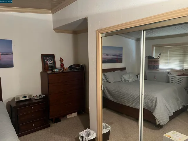 a view of a car parked in back yard of a house