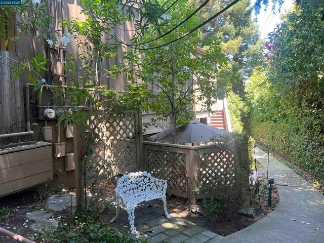 a view of a patio with table and chairs and potted plants