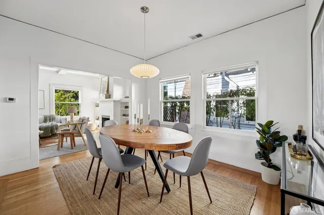 a large kitchen with granite countertop a stove top oven a sink a dining table and chairs