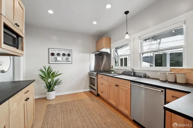 a bathroom with a sink a mirror and a window