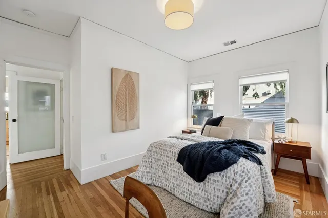 a view of a patio with table and chairs with wooden floor and fence