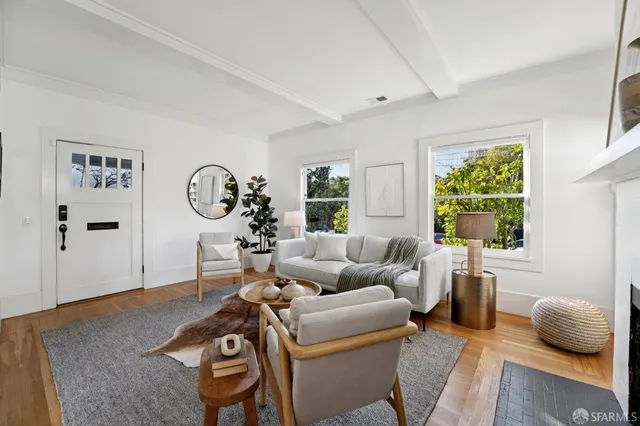 a living room with furniture a table and a fireplace