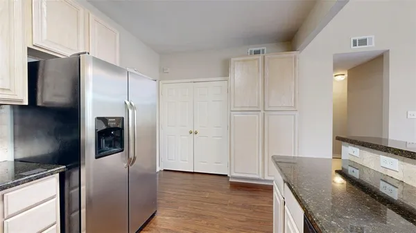 a kitchen with stainless steel appliances granite countertop a refrigerator and a stove