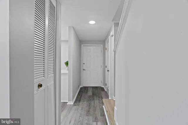 a view of a hallway with wooden floor