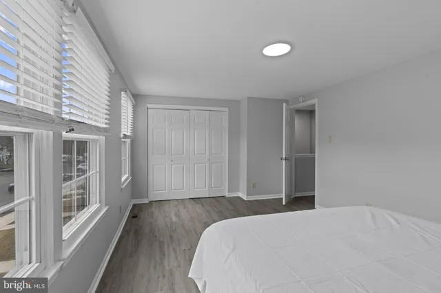 a bedroom with a bed and a large window