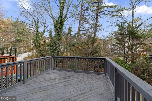 a balcony with wooden fence and floor