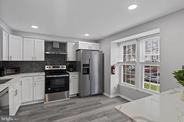 a kitchen with stainless steel appliances a refrigerator stove and sink