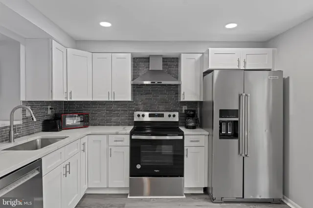 a kitchen with a refrigerator and a sink