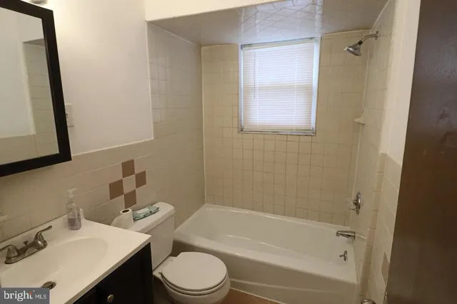 a bathroom with a sink toilet vanity and shower