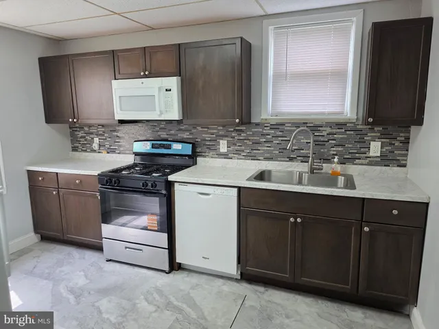 a kitchen with stainless steel appliances a stove sink and cabinets