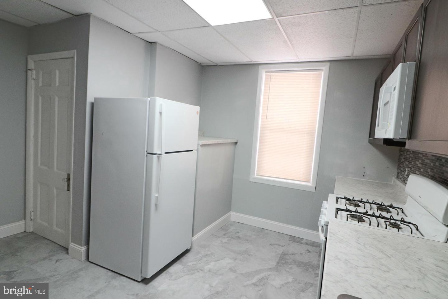 506 Ridgeway Street Gloucester City, NJ 08030 - Photo 10 of 10 a refrigerator freezer sitting in a kitchen