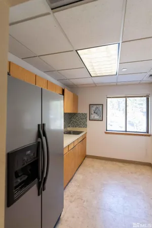 a kitchen with a refrigerator and a window