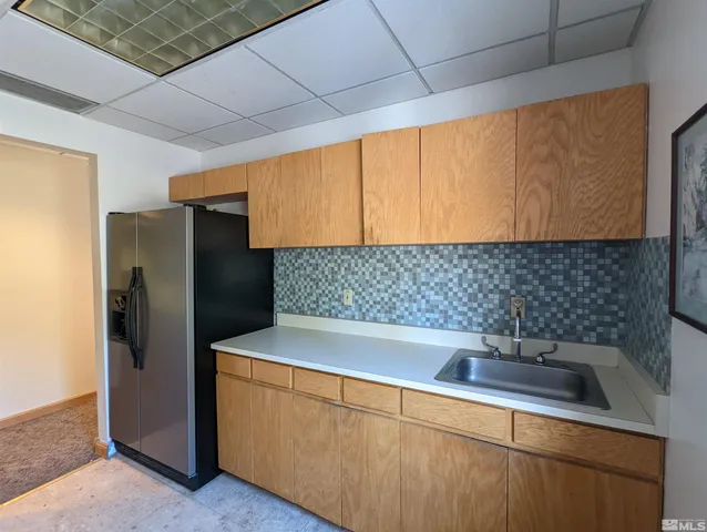a kitchen with stainless steel appliances a sink and a refrigerator