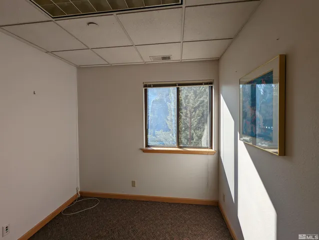 a view of room with window and hallway