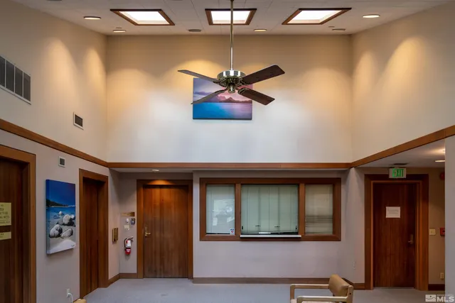 a living room with furniture and a ceiling fan