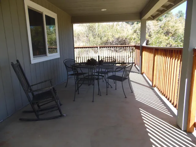 a view of a porch with chairs and backyard