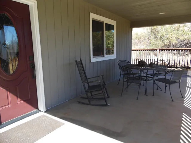 a dining room with furniture and a floor to ceiling window