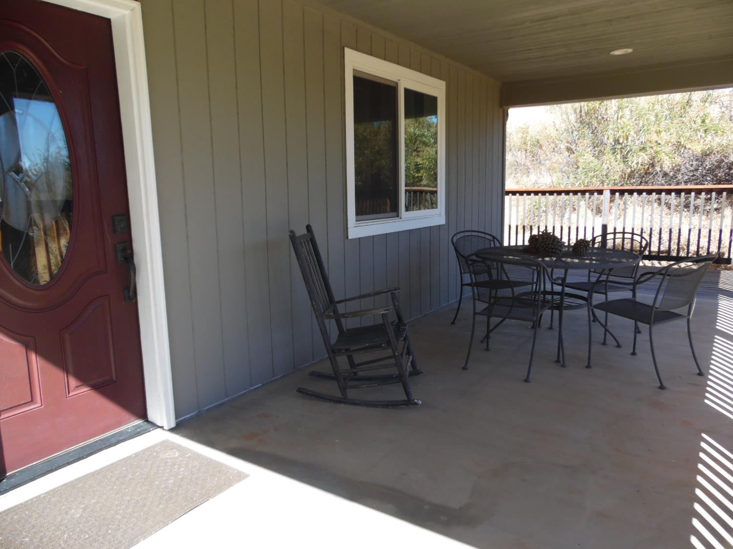 10006 Wendell Road Mountain Ranch, CA 95246 - Photo 18 of 37 a dining room with furniture and a floor to ceiling window