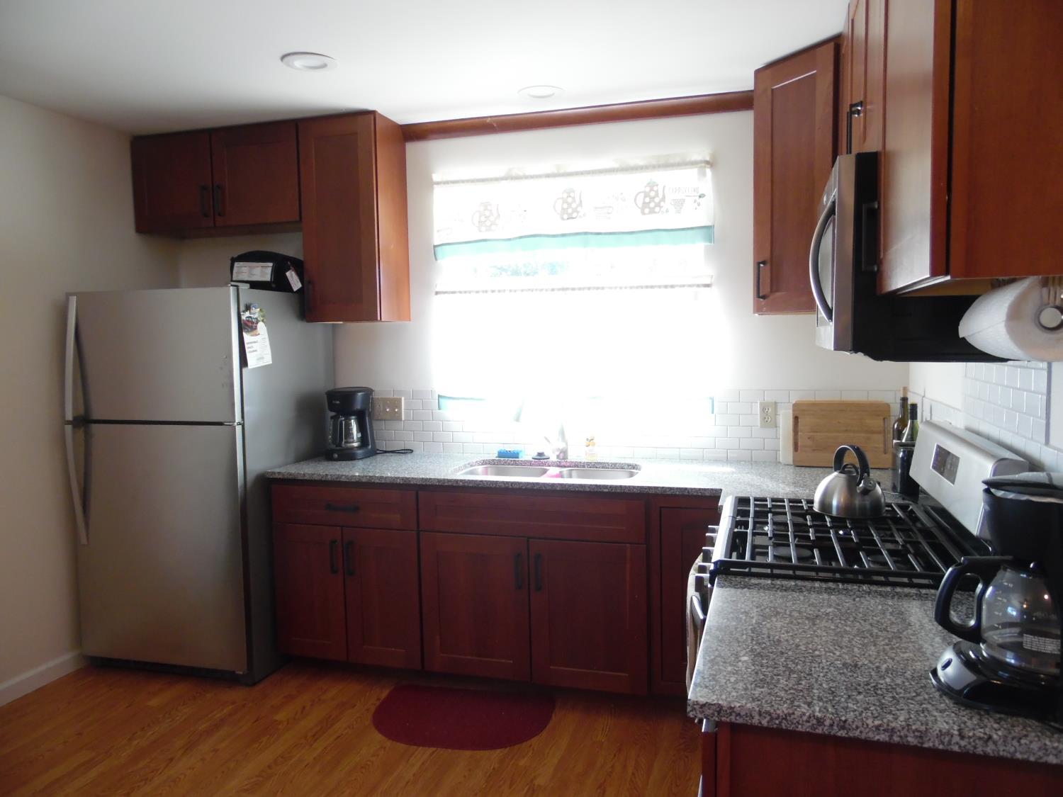10006 Wendell Road Mountain Ranch, CA 95246 - Photo 25 of 37 a kitchen with granite countertop a refrigerator stove and sink