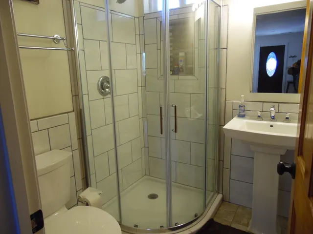 a bedroom with a bed and a mirror