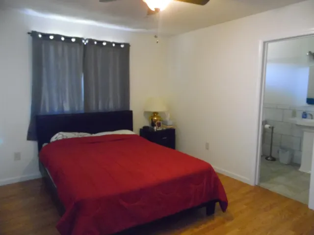 a living room with dining room and wooden floor