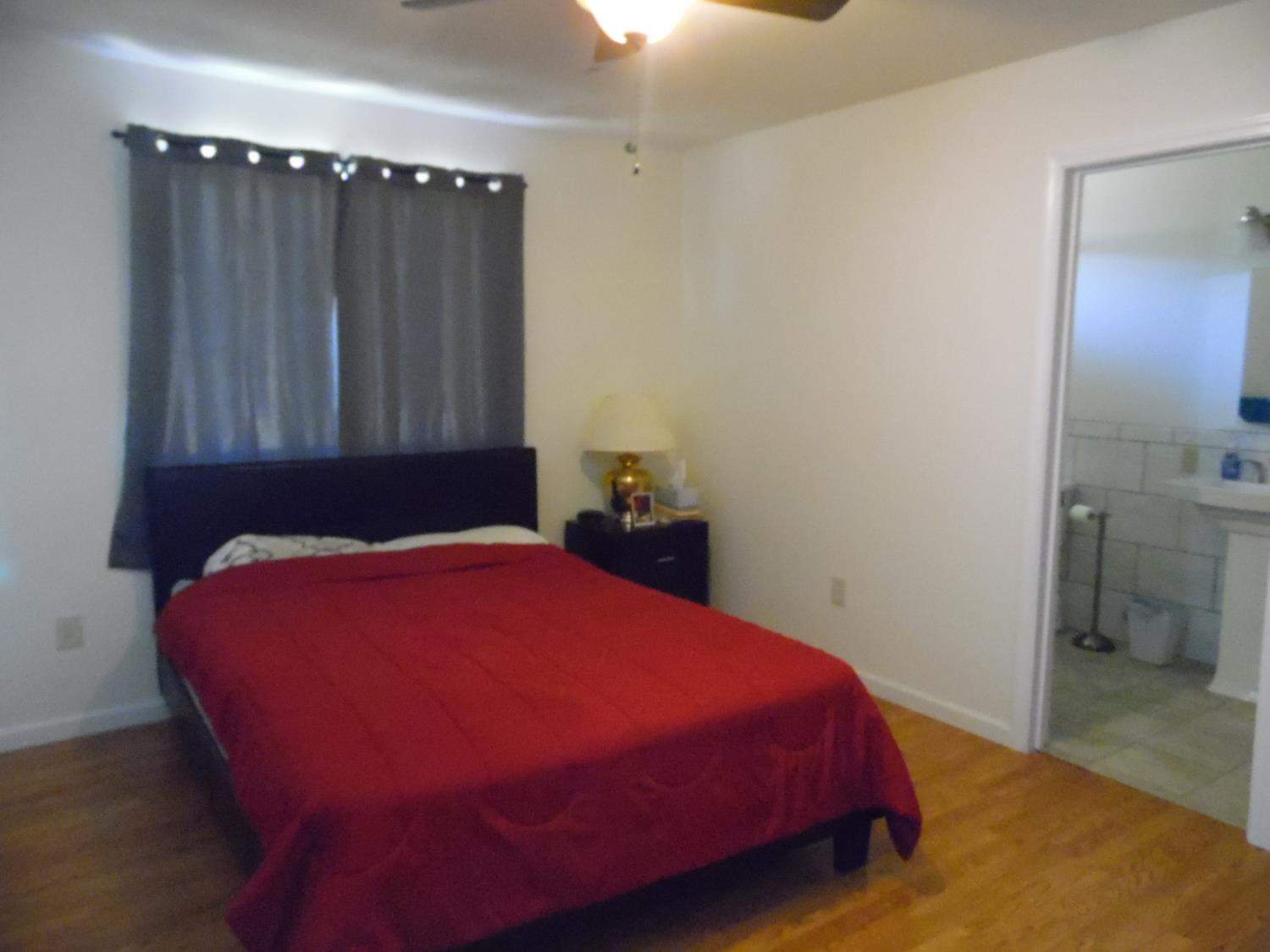 10006 Wendell Road Mountain Ranch, CA 95246 - Photo 33 of 37 a bedroom with a bed and a mirror