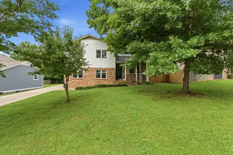 a view of a house with a backyard