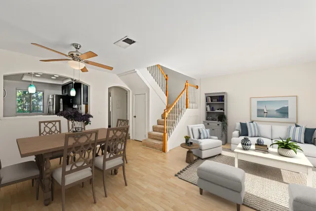 a living room with furniture a fireplace and a chandelier
