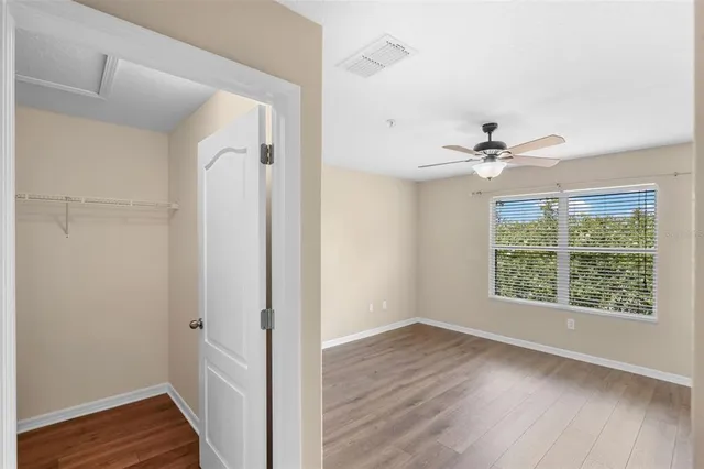a view of a livingroom with a window and wooden floor