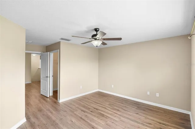 a view of a room with wooden floor