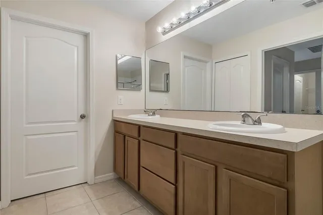 a bathroom with a double vanity sink and a mirror