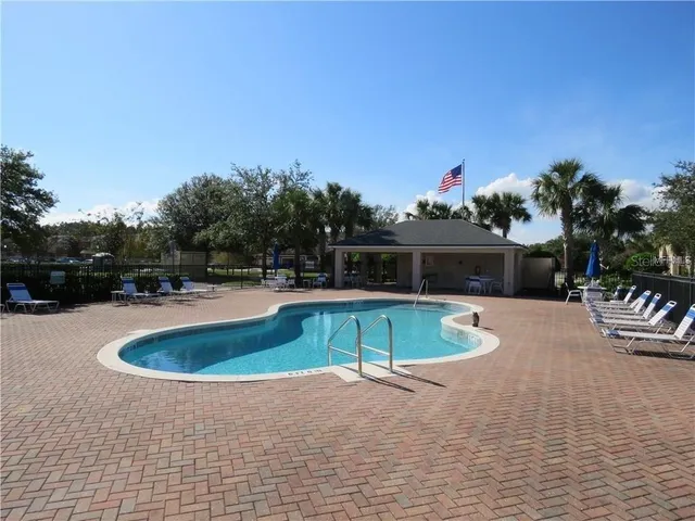 a swimming pool with outdoor seating and yard