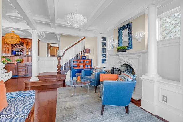 a living room with fireplace furniture and a chandelier