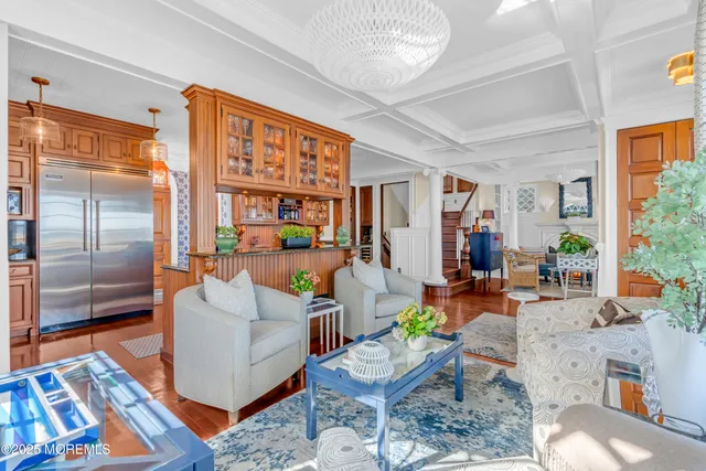 a living room with patio furniture and a flat screen tv