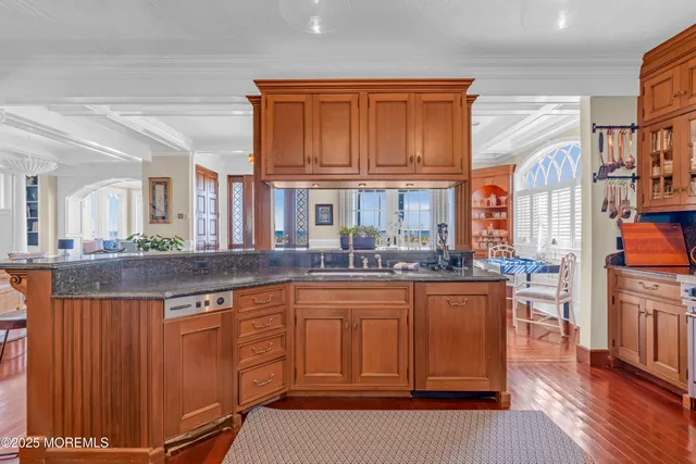 a patio with a table and chairs and potted plants