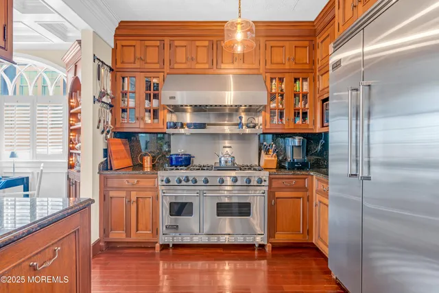 a front view of a house with a garden and potted plants
