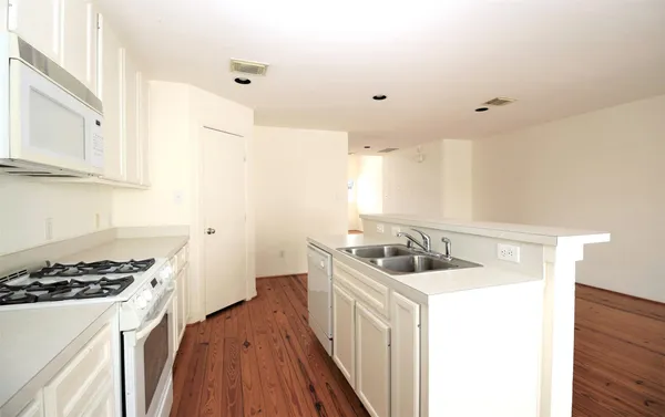 a kitchen that has a sink and a stove