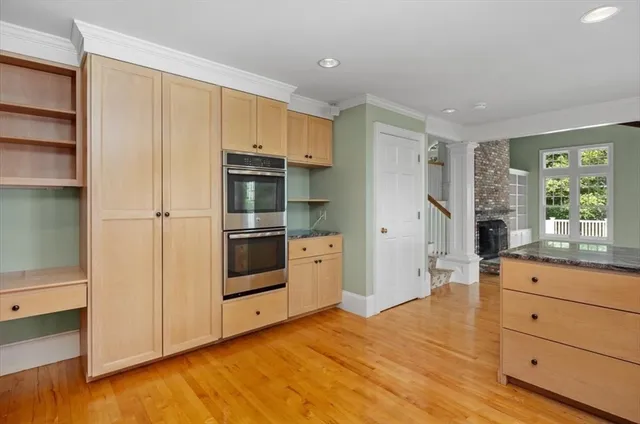 a view of kitchen with wooden floor and electronic appliances