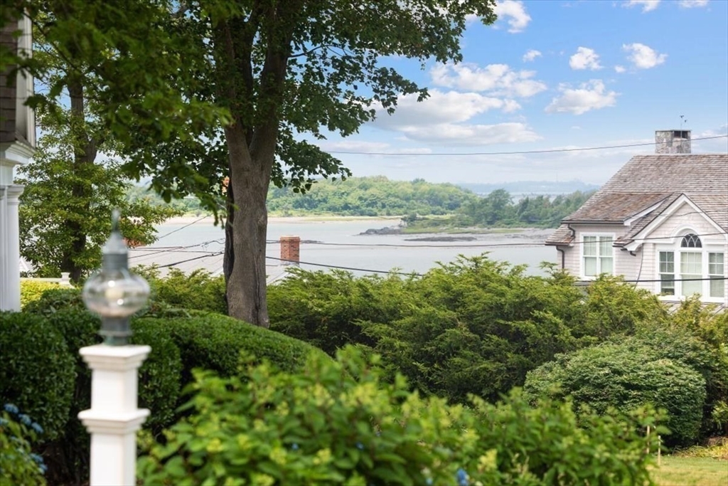 26 Bel Air Road Hingham, MA 02043 - Photo 2 of 41 a view of a lake with a house in the background