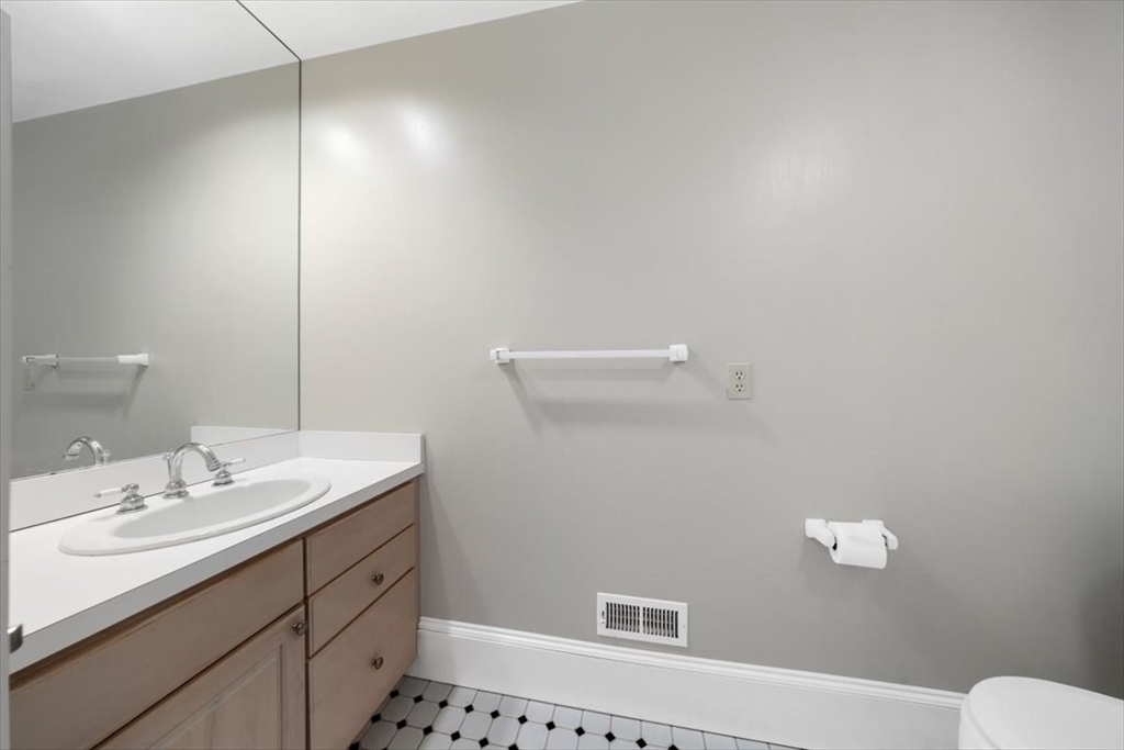 26 Bel Air Road Hingham, MA 02043 - Photo 31 of 41 a bathroom with a sink a toilet and a mirror