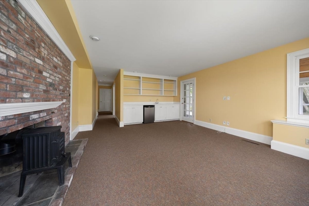 26 Bel Air Road Hingham, MA 02043 - Photo 34 of 40 a view of a house with a fireplace and workspace