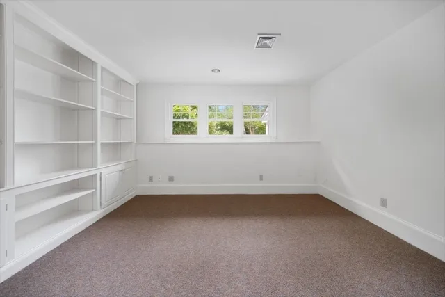 a front view of a house with a garden and plants