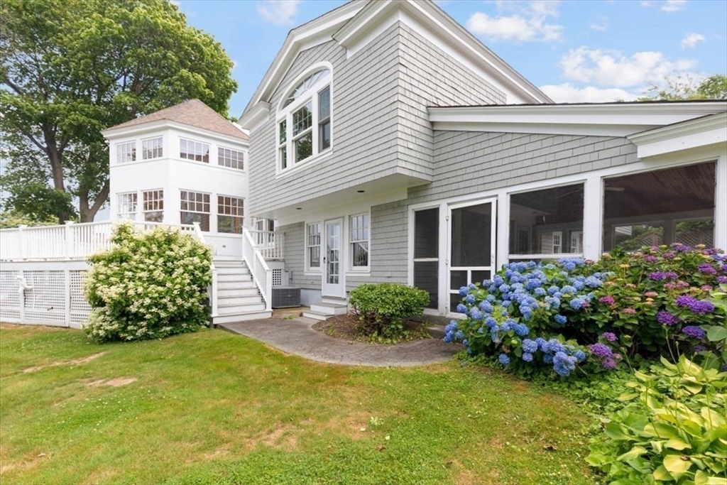 26 Bel Air Road Hingham, MA 02043 - Photo 38 of 40 a front view of a house with a garden and plants