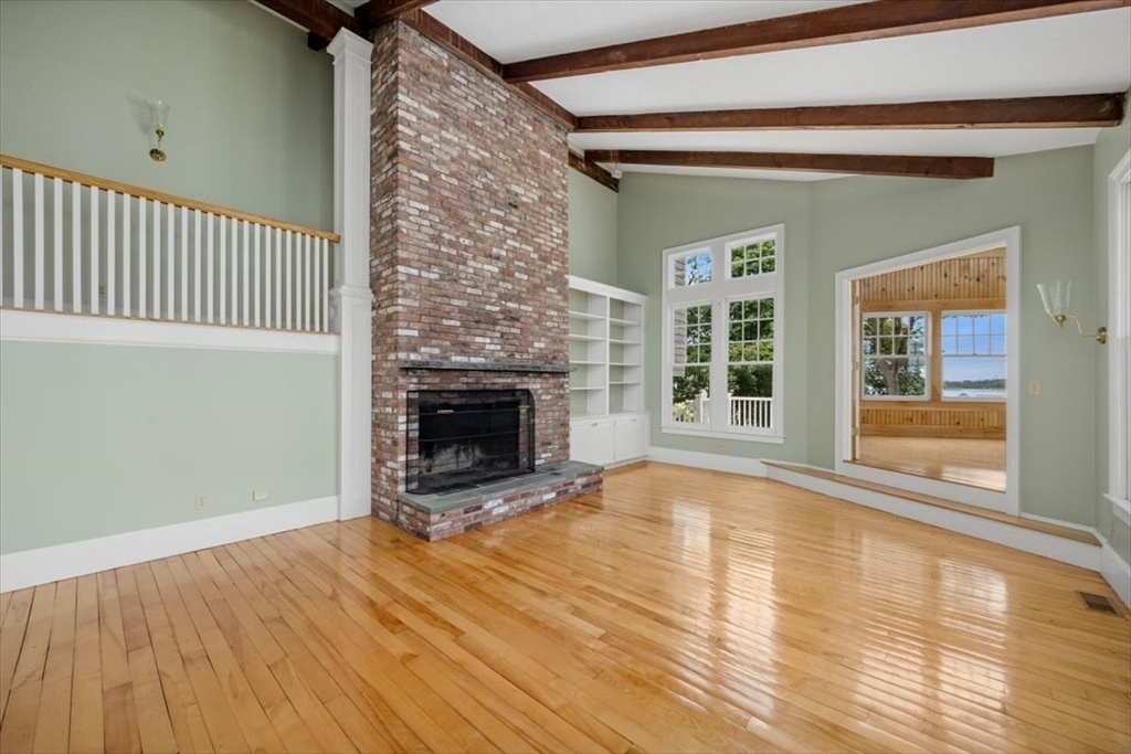 26 Bel Air Road Hingham, MA 02043 - Photo 9 of 41 a view of empty room with wooden floor and fireplace
