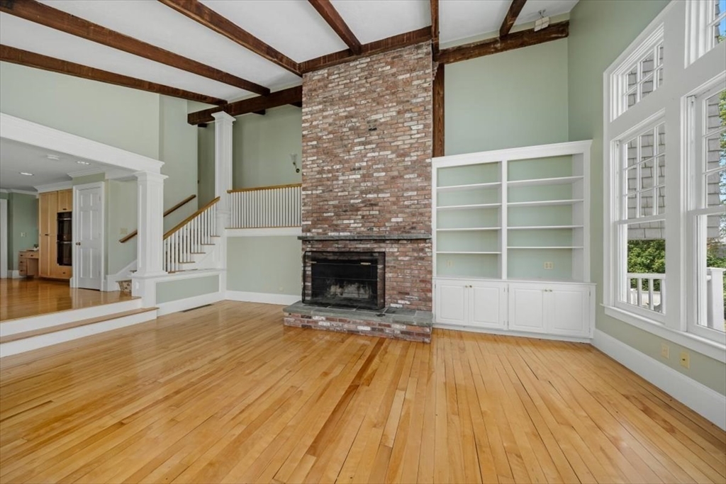 26 Bel Air Road Hingham, MA 02043 - Photo 10 of 41 a view of empty room with wooden floor and fireplace