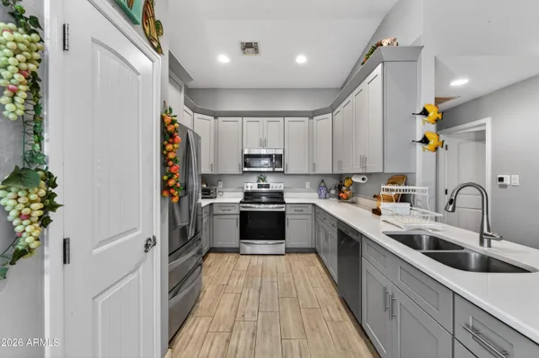 a kitchen with a refrigerator and a sink