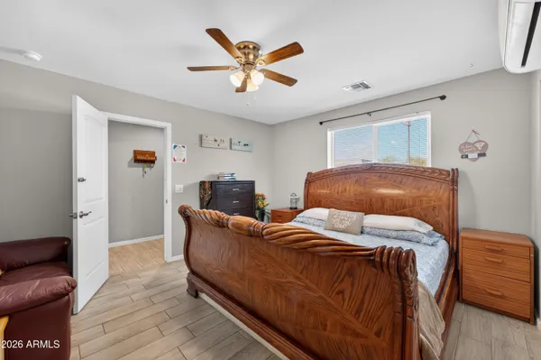a bedroom with a large bed and a chandelier