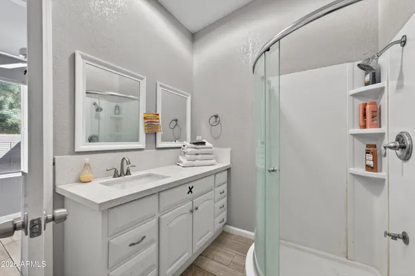 a living room with a couch and a wooden floor