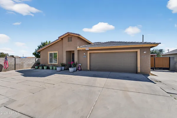 a front view of a house with yard and garage